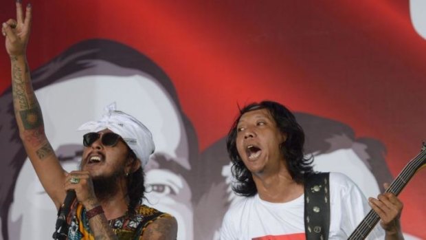 Supporters of Joko Widodo perform on stage at the Jokowi Center in Jakarta on Wednesday.