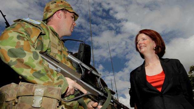 Julia Gillard talks to Trooper Mitchell Mc Waters at Lavarack Barracks in Townsville.