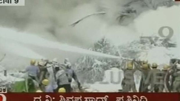 Firefighters spray water on a plane in Mangalore, India.