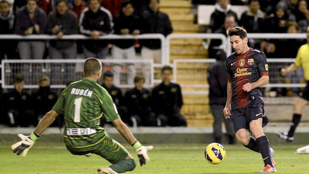Lionel Messi scores for Barcelona against Rayo Vallecano.