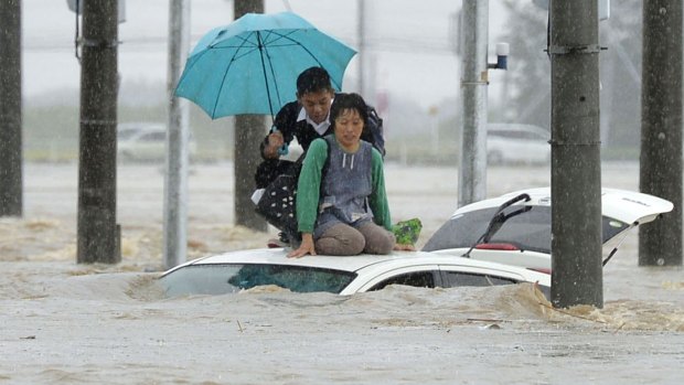 People wait for help in the town of Joso, north-east of Tokyo.