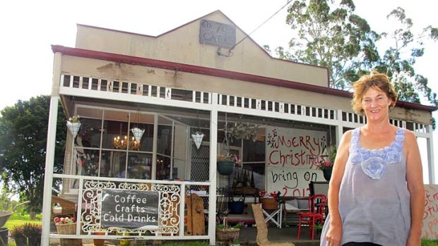 Christine Blackmore in front of her store, which she considered leaving behind forever after the flood tore it apart.