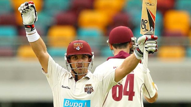 Chris Hartley raises his bat in triumph after scoring a decisive century in the Sheffield Shield final against Tasmania.