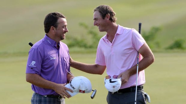 You've got to laugh: Nicolas Colsaerts, right, congratulates Graeme McDowell after  the quarter final on day three of the World Match Play Championship.