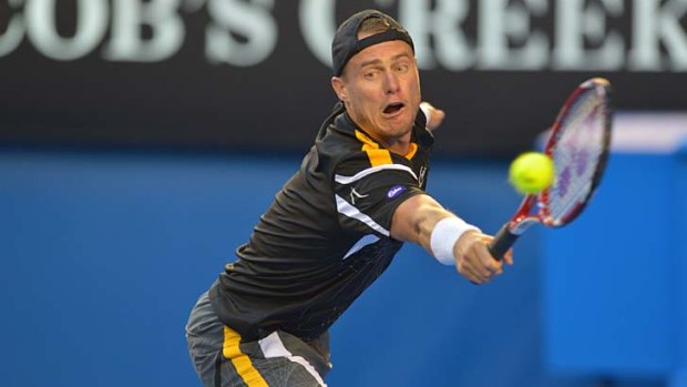 Strain ...  Lleyton Hewitt stretches to return a Tipsarevic shot on Monday night.