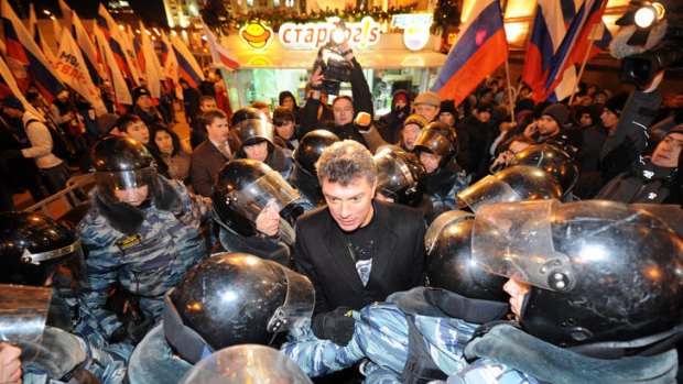Riot police encircle Russian opposition leader Boris Nemtsov, centre, during an unauthorized rally on Triumfalnaya Square in Moscow.