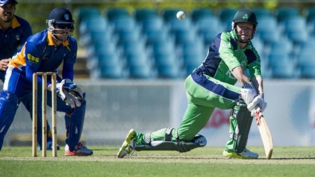 Nial O'Brien of Ireland plays a sweep shot against the ACT Comets at Manuka Oval.