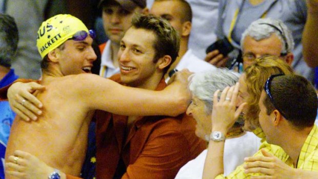 Long distance king ... Grant Hackett embraces Ian Thorpe after claiming the 1500m race in Sydney.