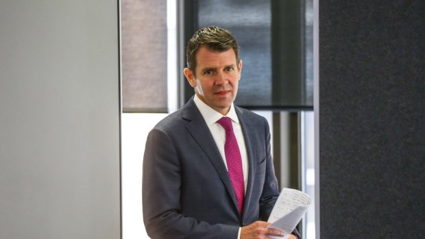 Premier Mike Baird arrives at the press conference to announce proposals for local government on Friday.