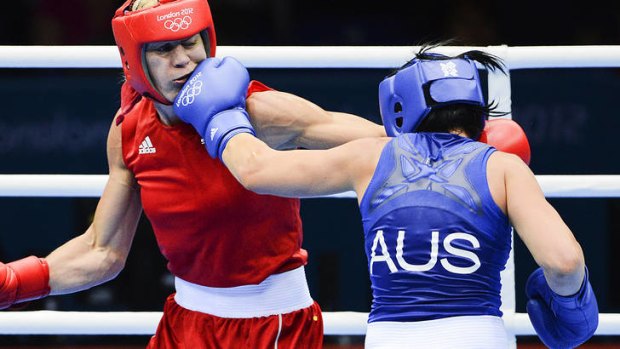 No holding back ... Australia's Naomi-Lee Fischer-Rasmussen scores with a left jab against Sweden's Anna Laurell in their middleweight (75kg) fight.