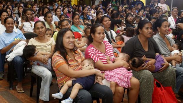 Mothers breastfeed their babies in Manila as they take part in a nationwide record-breaking attempt.