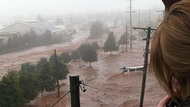 A photo taken by a member of the public watching last week's Toowoomba floods from the Grand Central Shopping Centre, looking on to Dent Street. A person is visible in the bottom right corner.