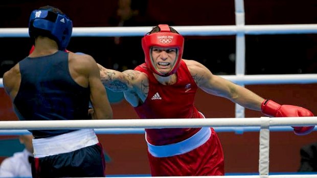 Australian boxer Damien Hooper, red, lands a right hand on the USA's Marcus Browne during his first round Olympics light heavyweight boxing victory.