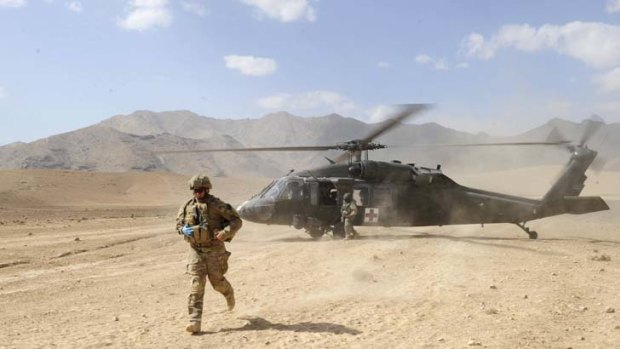An Australian soldier leaves a US Blackhawk helicopter in Afghanistan.