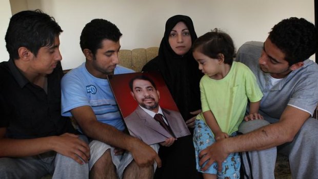Wafaa Almaribe with her sons Mohammad, Jamal, Isaam and baby Wally with a photograph of her husband Mansor Almaribe.