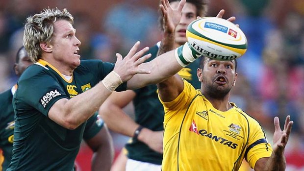 Eyes on the prize &#8230; Kurtley Beale competes for the ball with Jean de Villiers.