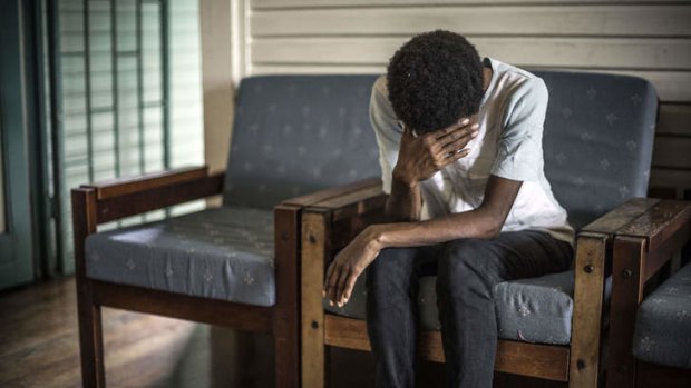 Amanda, whose first attempt to jail her husband failed, sits on a sofa in Port Moresby, Papua New Guinea.