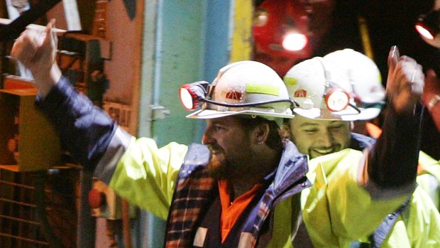 Miners Todd Russell, left, and Brant Webb, smile as the arrive above ground after spending two weeks trapped nearly a kilometre (3,000 feet) underground in the Beaconsfield Gold Mine at Beaconsfield, Australia, Tuesday, May 9, 2006. After initial medical tests underground, Webb, 37, and Russell, 34, strode purposefully from the mine's main lift shaft and hugged family and friends before clambering into two ambulances, still laughing and joking with friends.  (AP Photo/Ian Waldie, Pool)