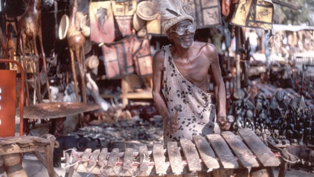 A man plays a balafon at Victoria Falls.