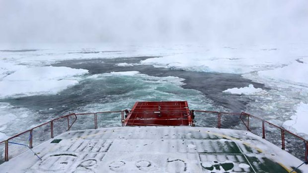 All white: A view from the stern of the  Aurora Australis as it punches its way through sea ice towards the Akademik Shokalskiy.