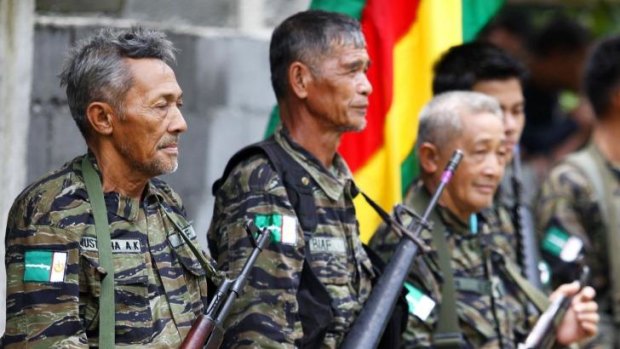 Elderly Moro Islamic Liberation Front rebels stand guard at a news conference in 2012.