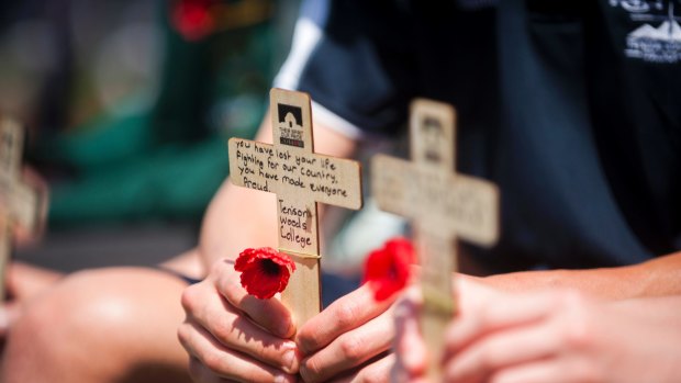 Students wrote messages for fallen servicemen and women before laying them on the Stone of Remembrance.