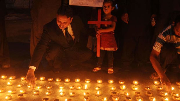 Pakistani Christians light candles during a protest in Lahore following the suicide bombing of a church in Peshawar that killed 85 Christians.