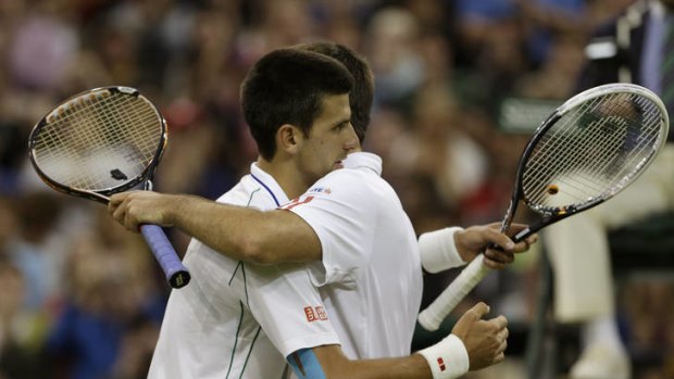 Novak Djokovic of Serbia, (left) embraces friend and countryman Viktor Troicki after their Wimbledon clash.