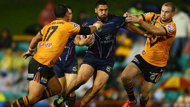 Charging on: Melbourne's Jesse Bromwich tries to break through Wests Tigers rivals at Leichhardt Oval.