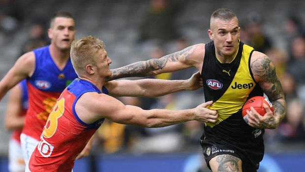 The Brisbane Lions' Nick Robertson meets Dusty's specialty, the open-handed fend-off. 