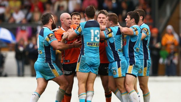 Players argue as Wests Tigers are thumped by the Titans.