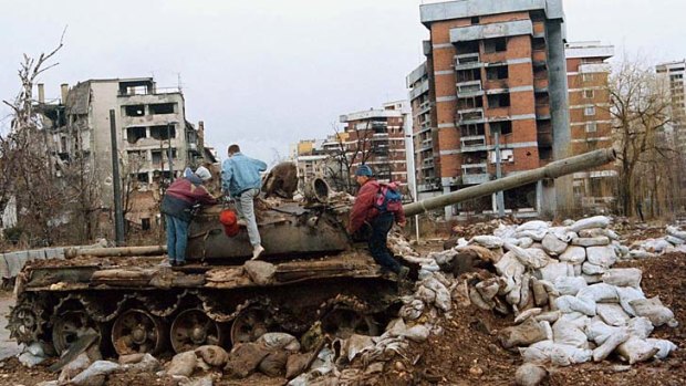 War torn: Children play atop a Serbian tank in Sarajevo, the city where Hemon grew up.
