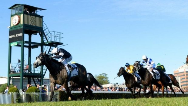 Fawkner, ridden by Nicholas Hall, wins the Caulfield Cup in 2013.