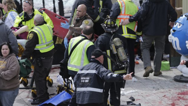 Blood can be seen all over the road as the wounded are attended to.