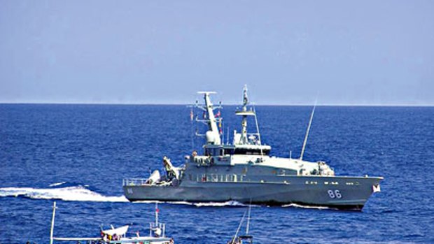 No way in . . . HMAS Albany shadows the fishing boat containing 54 Afghan asylum seekers near Ashmore Island off  Australia's north-west coast yesterday.