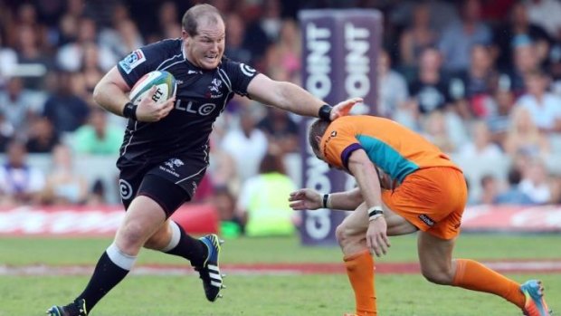 Too sharp: Lourens Adriaanse of the Sharks beats Sarel Pretorius during his side's easy Super Rugby win which saw them consolidate top spot.