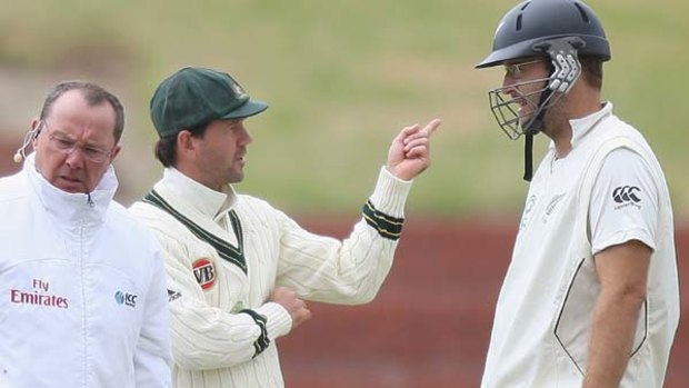 Blowing up . . . Ricky Ponting has a discussion with New Zealand captain Daniel Vettori after use of the video referral system was halted by high winds.