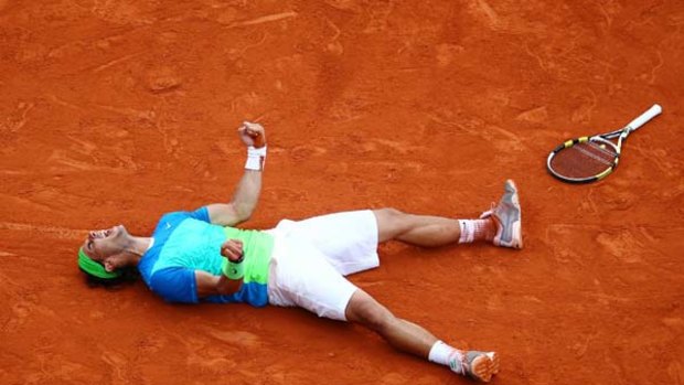 Rafael Nadal celebrates after winning his fifth French Open title and regaining the top spot in men's tennis from Roger Federer.