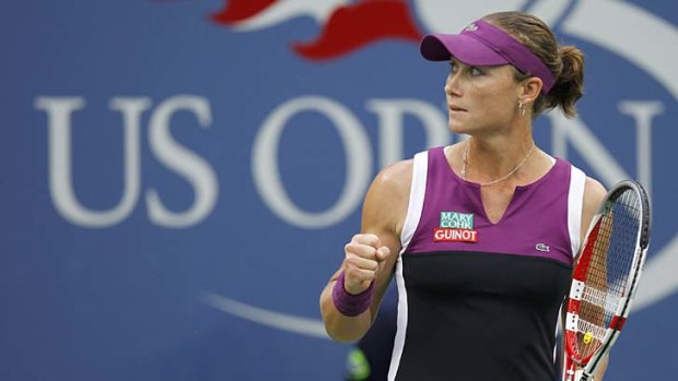 Samantha Stosur of Australia reacts after breaking the serve of Serena Williams.