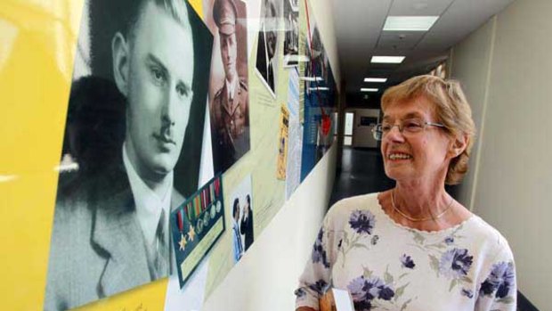 Sue Sherson admires a mural dedicated to psychiatrist John Cade, who pioneered the use of lithium to treat bipolar disorder.