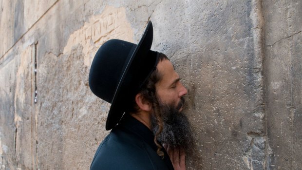 An ultra orthodox Jewish man at prayer outside Cave of Machpela in Hebron.