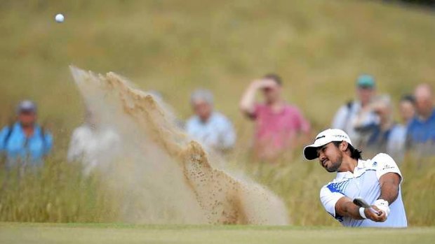 Jason Day of Australia hits from a bunker on the fifth hole during the first round of the British Open golf championship at Muirfield.