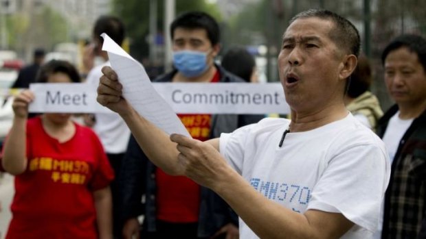 A relative of a passenger onboard the MH370 addresses media outside the Malaysian embassy in Beijing on Friday.