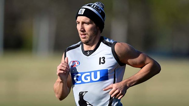 Beanie there, and done that ... Magpie Dale Thomas runs laps at training.