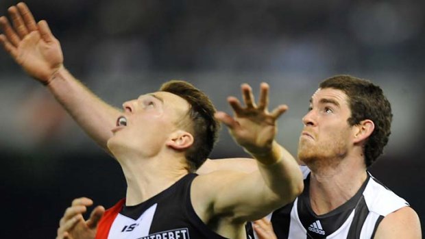 St Kilda's Brendon Goddard and Collingwood's Tyson Goldsack wait in anticipation for the ball.