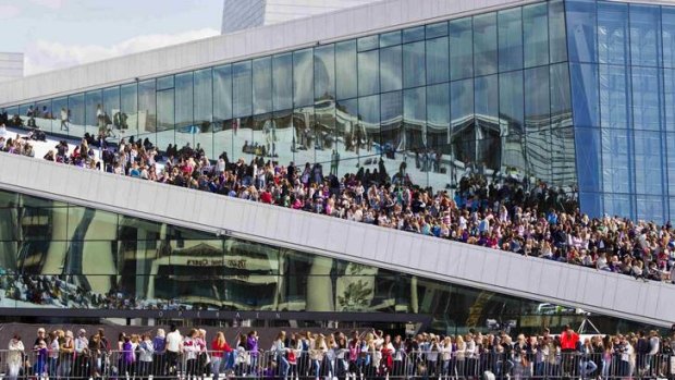 Hordes of young fans gather waiting for singer Justin Bieber to hold a free outdoor concert at the Oslo Opera House.