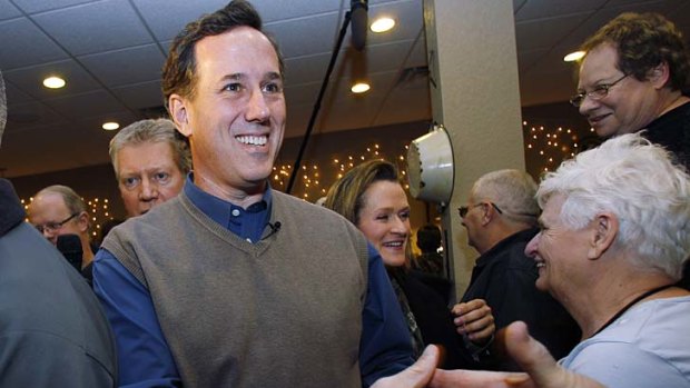 Rick Santorum, with wife Karen at his side, meets and greets at the Pizza Ranch restaurant in Newton, Iowa.