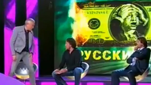 Alexander Lebedev gets out of his chair before punching fellow TV panellist Sergei Polonsky several times in the face.