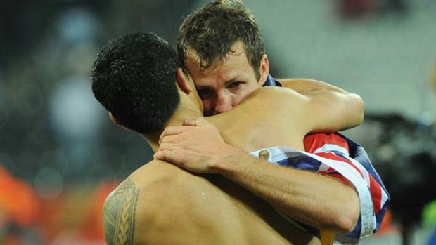 Sad end ... a shattered Tim Cahill and Lucas Neill console each other after Australia bowed out.
