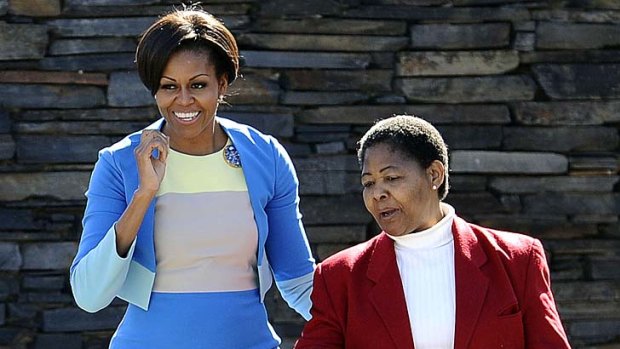 US first lady Michelle Obama with Antoinette Sithole, whose brother Hector Pieterson was killed in the 1976 student uprising in Soweto.